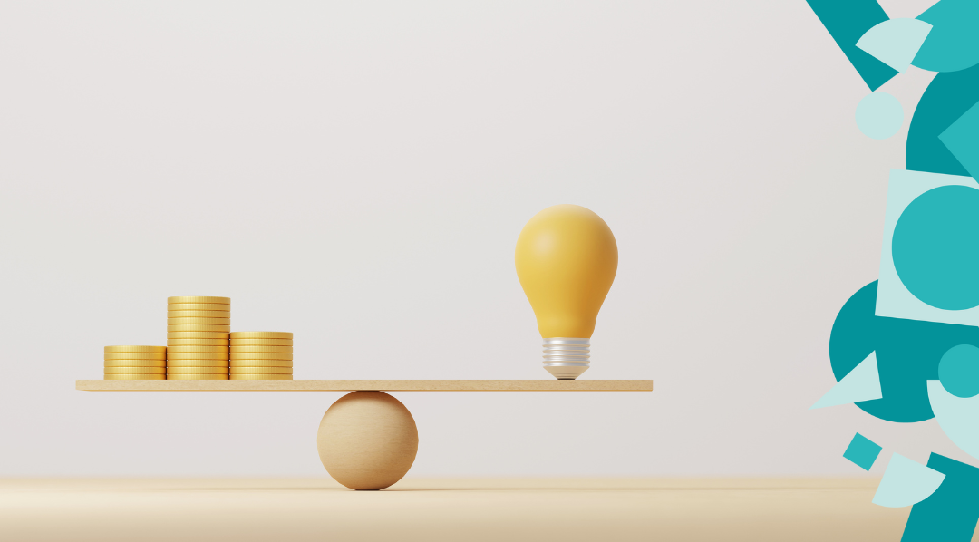 A see-saw with a stack of coins on one side and a light-bulb on the other